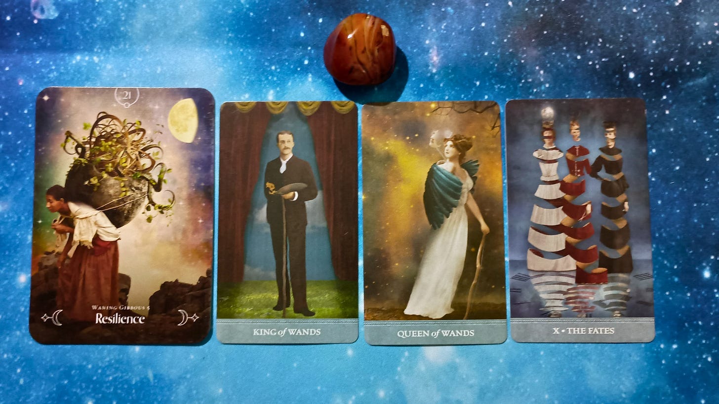 New Moon Magic: Your August 2025 Pick-a-Card Tarot Reading, pile 2 -Silk Agate stone (orange and brown) and 4 cards on a starry blue background