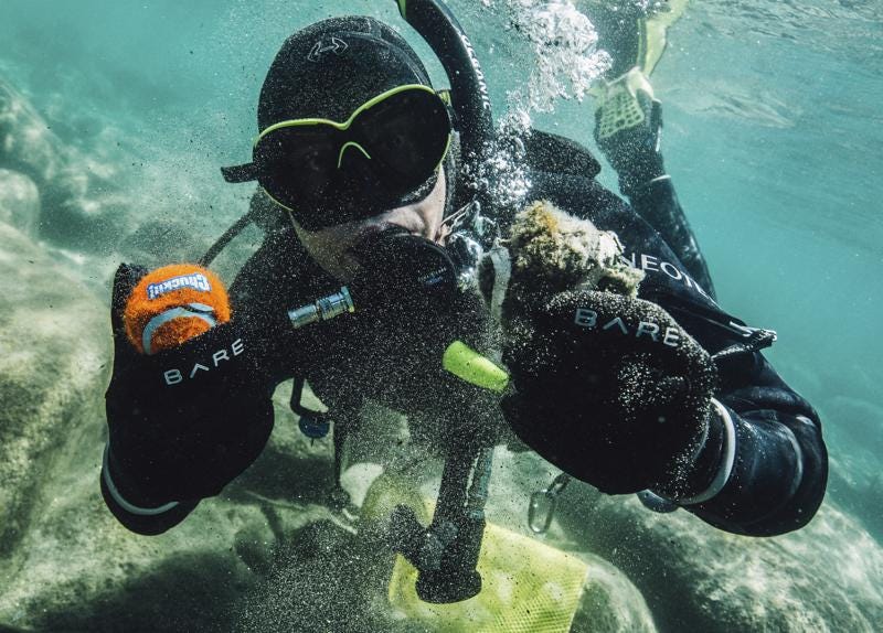 In this photo provided by Clean Up The Lake, CUTL diver Colin West shows debris found in the lake from an initial dive in 2020, at Lake Tahoe, Nev. They found no trace of a mythical sea monster, no sign of mobsters in cement shoes or long-lost treasure chests. But scuba divers who spent the past year cleaning up Lake Tahoe's entire 72-mile (115-kilometer) shoreline have come away with what they hope will prove much more valuable: tons and tons of trash. (Ludovic Fekete/Clean Up The Lake via AP)