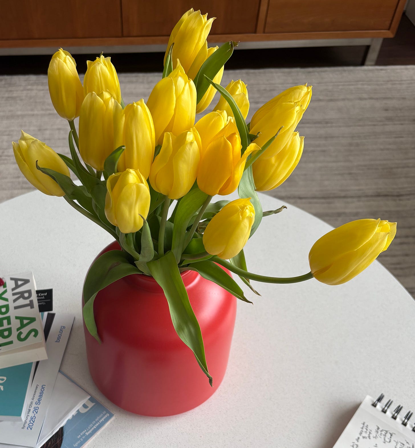 yellow tulips in a red vase