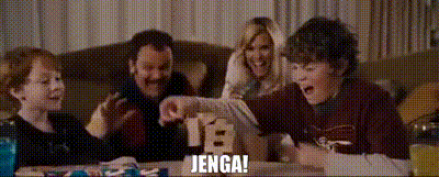 GIF from Talladega Nights (2006): A boy gleefully yells “JENGA!” as a block tower collapses, cheered on by laughing adults.