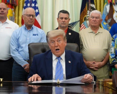 Donald Trump speaks to the press while sitting behind a desk in the Oval Office Donald Trump speaks to the press while sitting behind a desk in the Oval Office