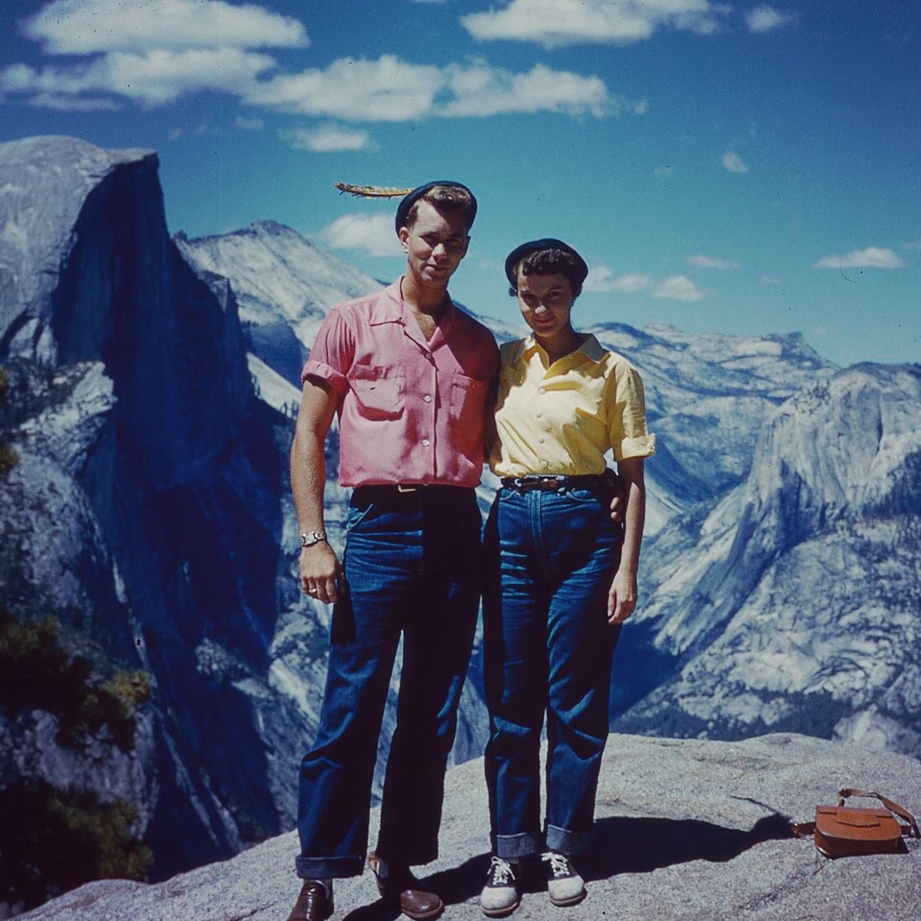 a young couple in the 1950s standing on a mountainside in Yosemite National Park