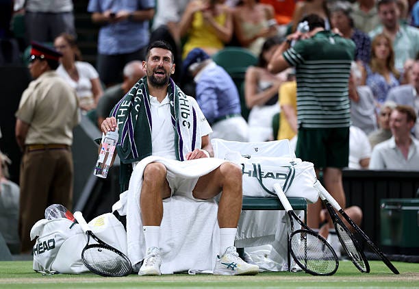 Novak Djokovic of Serbia reacts against Felix Auger-Aliassime of Canada during their Gentlemen's Singles quarterfinal match on day nine of The...