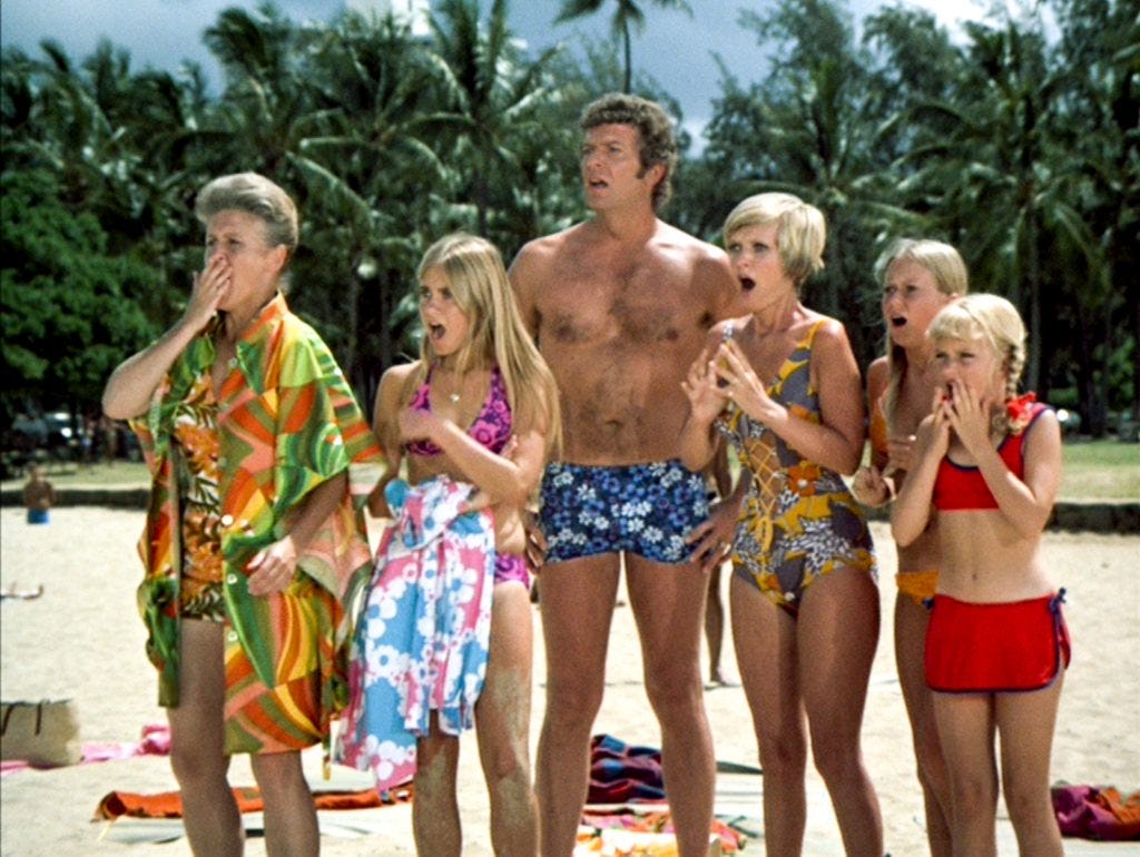 Bradys on Hawaii beach look shocked and appalled. I think maybe Greg just wiped out. 