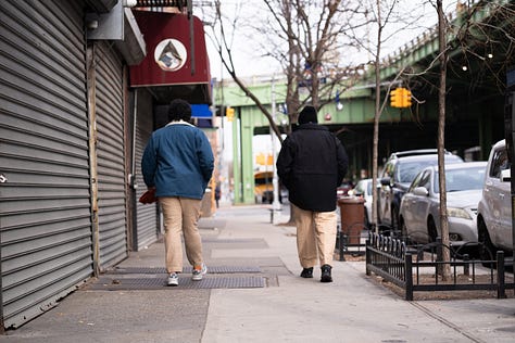 person holding fabrics photographed in the mirror, stylish model wearing a khadi suit, two people walking away wearing khadi pants
