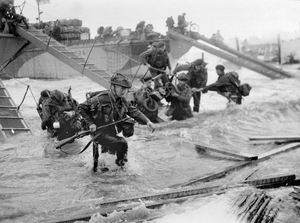 Troops wading ashore from landing craft, 6 June 1944