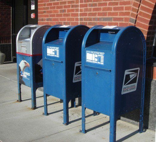 This may contain: three mailboxes are lined up next to each other in front of a brick building