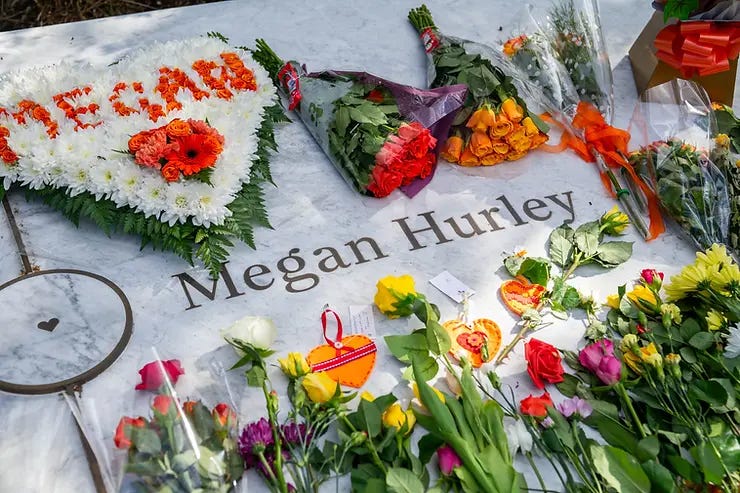 Floral tributes have been laid by each persons name on the marble circle. Floral tributes have been laid by each persons name on the marble circle.