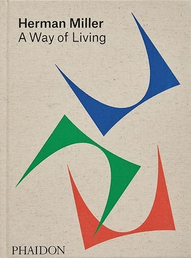 Book cover: Herman Miller: A Way of Living published by Phaidon, featuring three abstract Calder-style shapes in blue, green, and red on a linen-textured background.