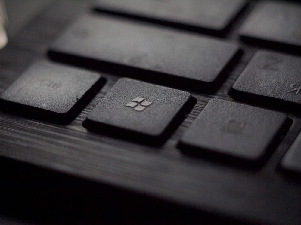 black laptop computer keyboard in closeup photo black laptop computer keyboard in closeup photo