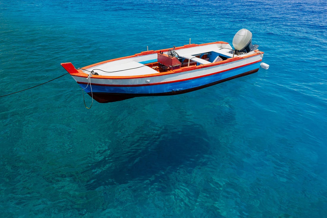 A small wooden fishing boat on the water in the Aeolian Islands, Sicily. A small wooden fishing boat on the water in the Aeolian Islands, Sicily.
