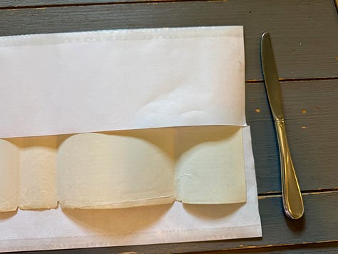 Steps 1-9 described below for how to wrap the Three Cities of Bells dust jacket in a mylar cover