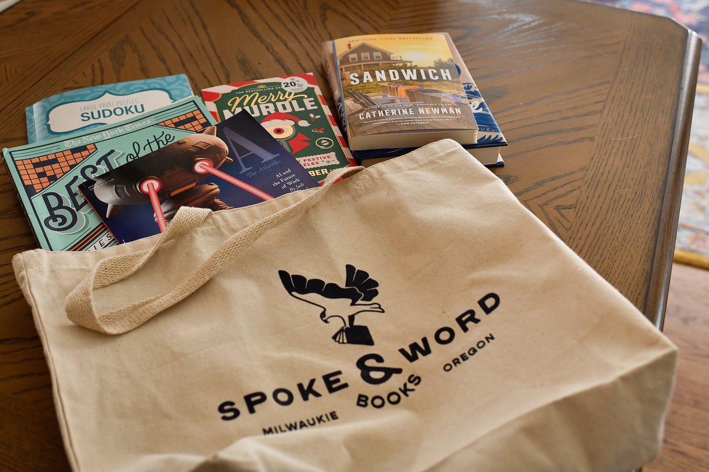 an analog bag filled with books and puzzle books on a table