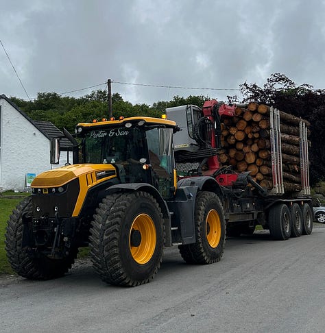 Tractor with log truck and logpile, and whisky bottle box