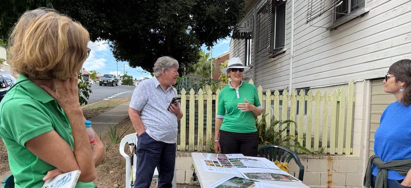 four people standing around a table talking