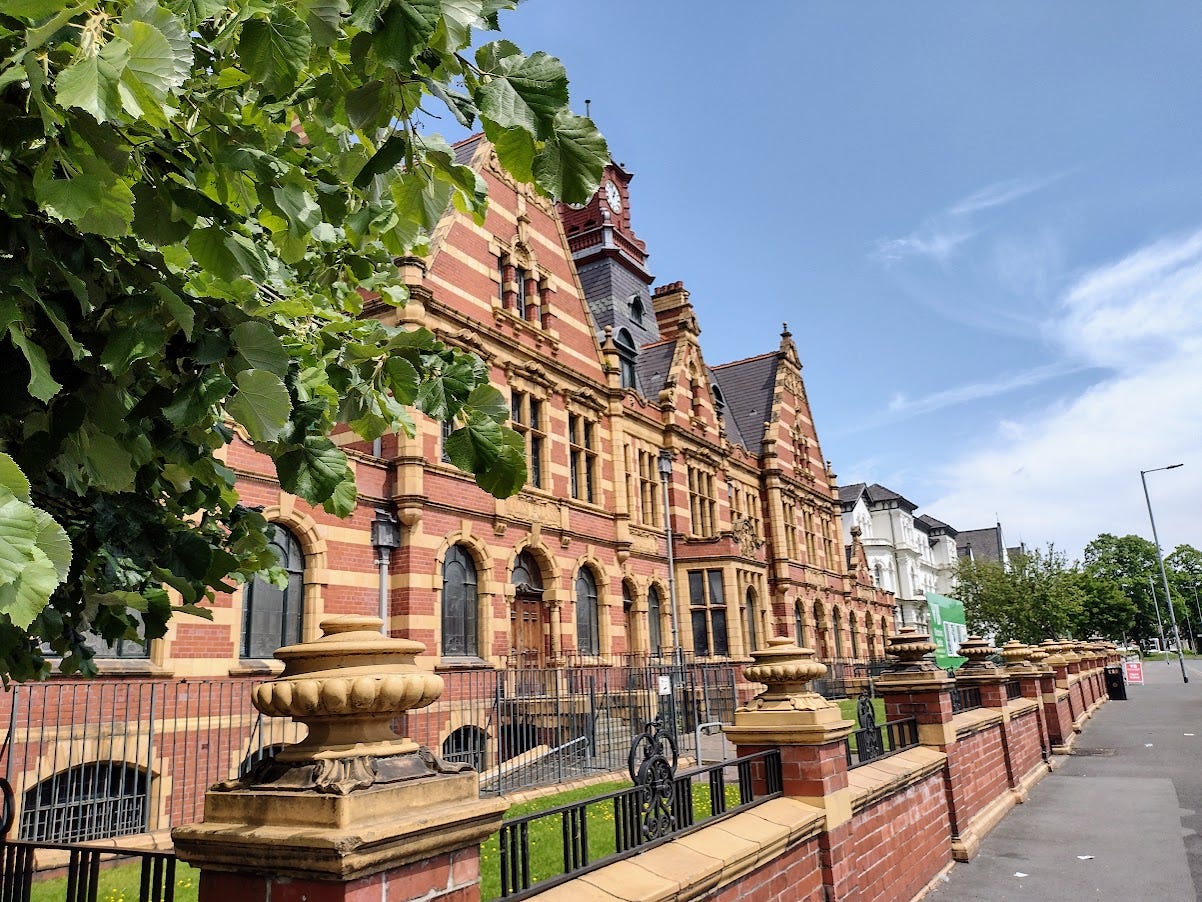 Large gabled brick building with clock tower Large gabled brick building with clock tower