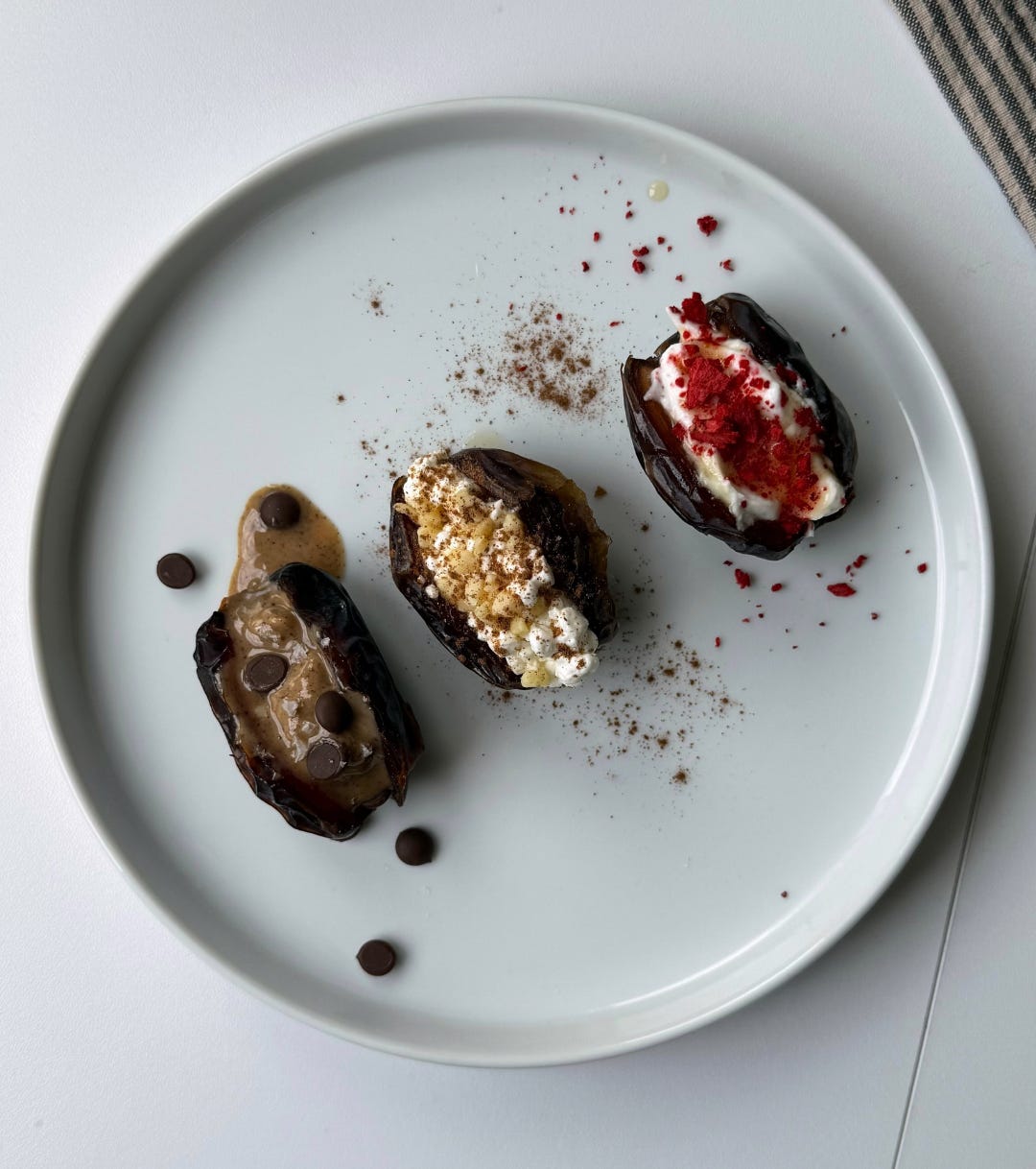 “Cottage cheese-stuffed dates topped with honey, nuts, and cinnamon, served as a quick and healthy protein snack.”