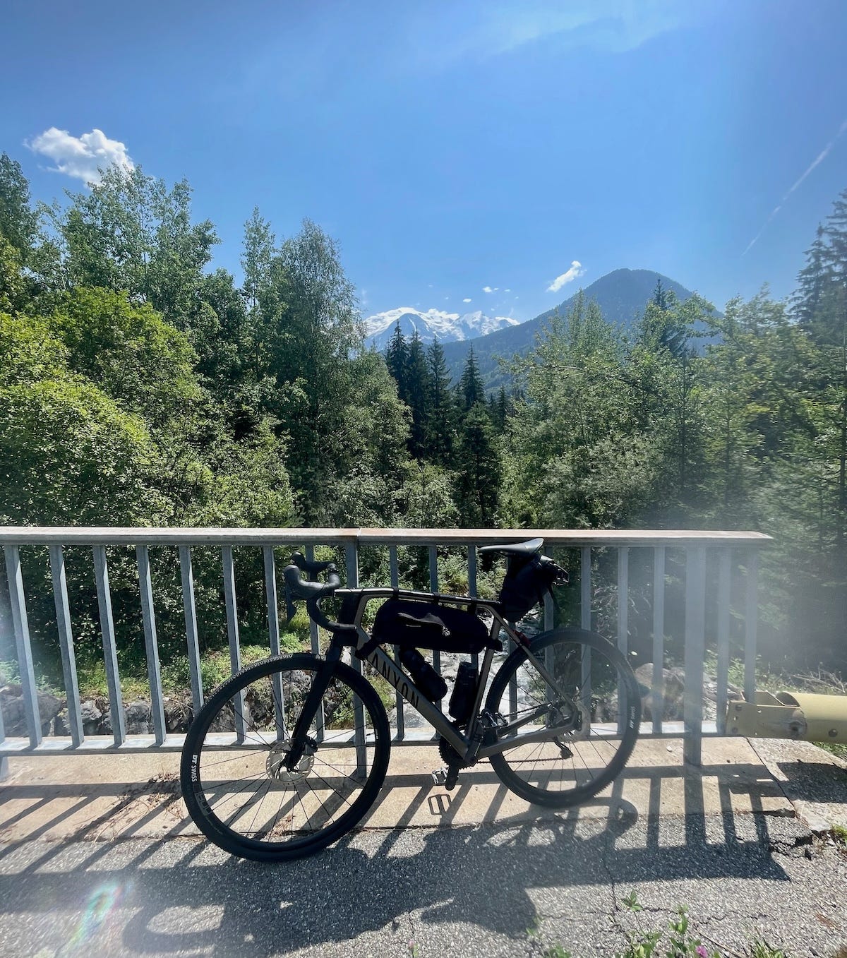 The author's gravel bike on a bridge in front of Mont Blanc