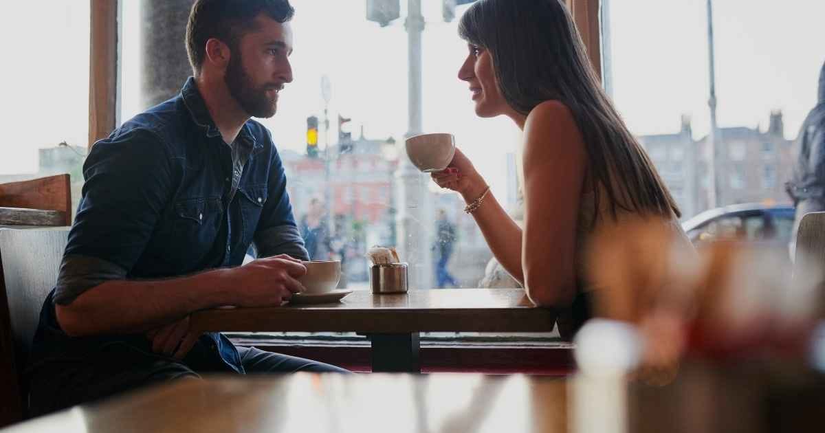 Young couple sitting in a coffee shop while on a date