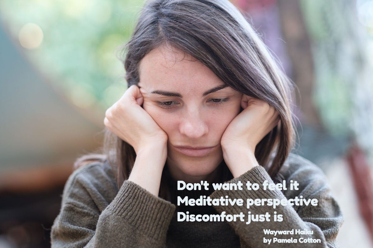 Closeup of woman, head held in hands, looking down and possibly discouraged.