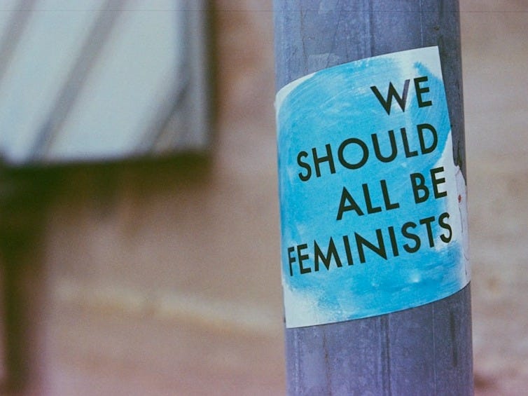 a blue and white sign on a pole a blue and white sign on a pole