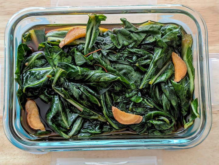 Collard greens in their brine and a small dish of the final pickled collard greens.