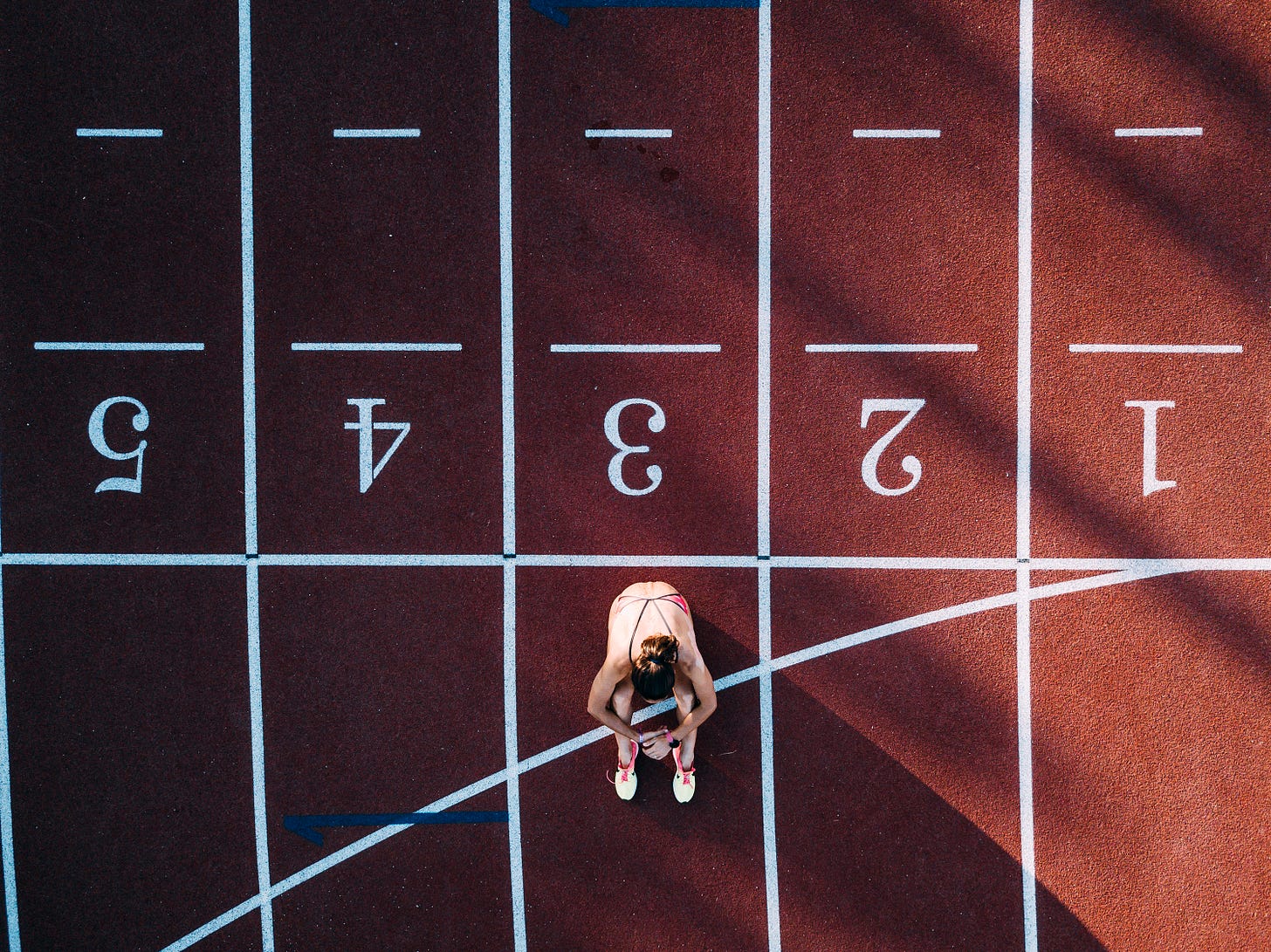 Top down look at a track with a woman sitting on the track 3.