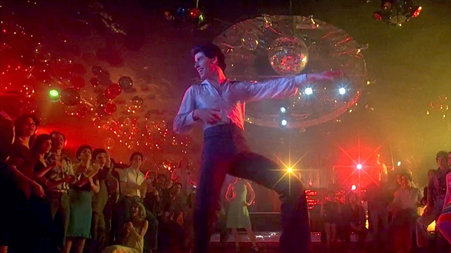 Tony Manero alone on the illuminated dance floor of the 2001 Odyssey. Tony Manero alone on the illuminated dance floor of the 2001 Odyssey.