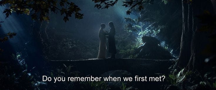 This may contain: two people standing on a bridge in the woods with text that reads do you remember when we first met?