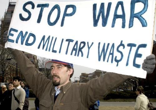 LEX BERMAN, a Harvard employee who works on Chinese language databases, protests an impending war in Iraq yesterday.