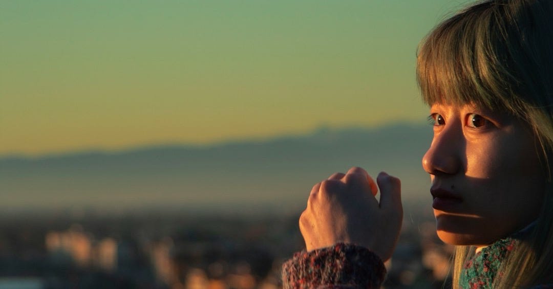 a woman standing in front of a city skyline