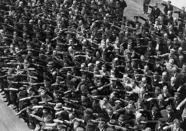 Can you spot the gentleman in the photo who is refusing to give the Nazi salute in June 1936? Can you spot the gentleman in the photo who is refusing to give the Nazi salute in June 1936?