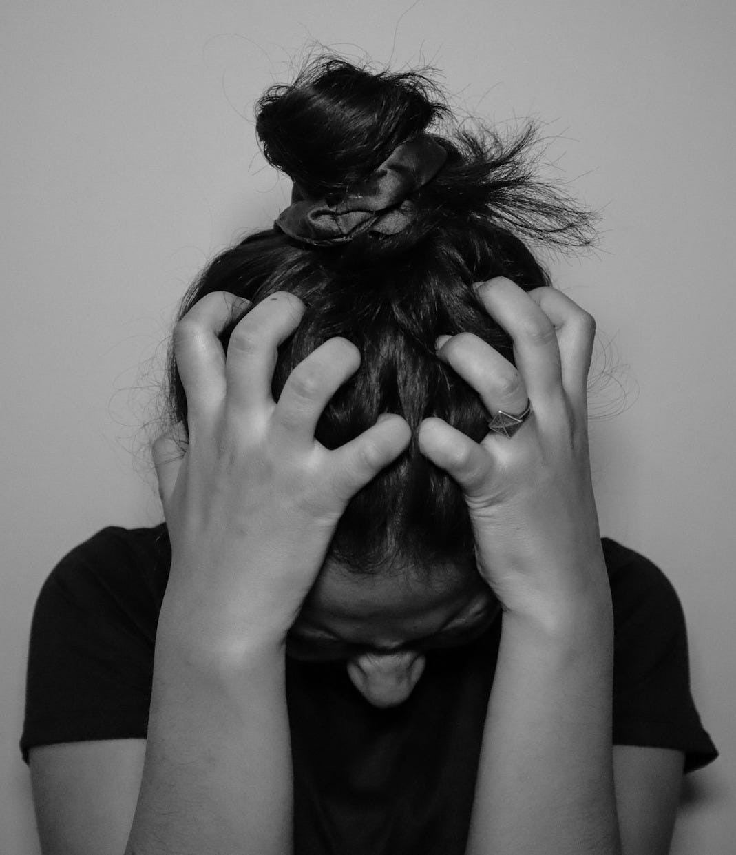 a woman covering her face with her hands