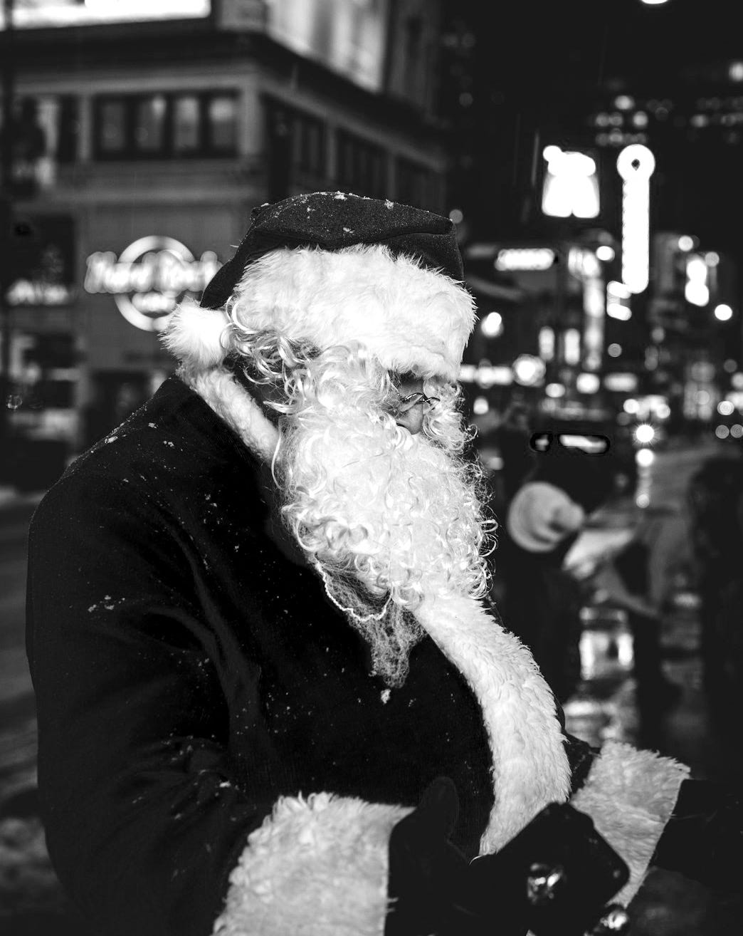 Santa Claus standing near buildings Santa Claus standing near buildings