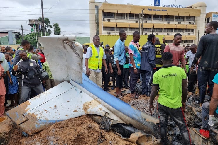 People crowd the wreckage after an aircraft crash landed in the Oba Akran area on August 1, 2023. Credit: NEMA / Twitter People crowd the wreckage after an aircraft crash landed in the Oba Akran area on August 1, 2023. Credit: NEMA / Twitter