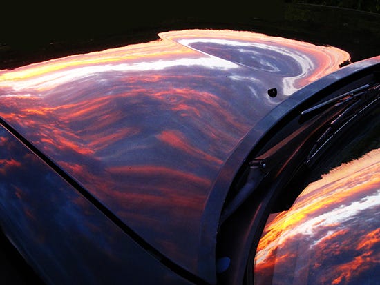 Photograph of Sunset Reflected on Miata by John Hulsey