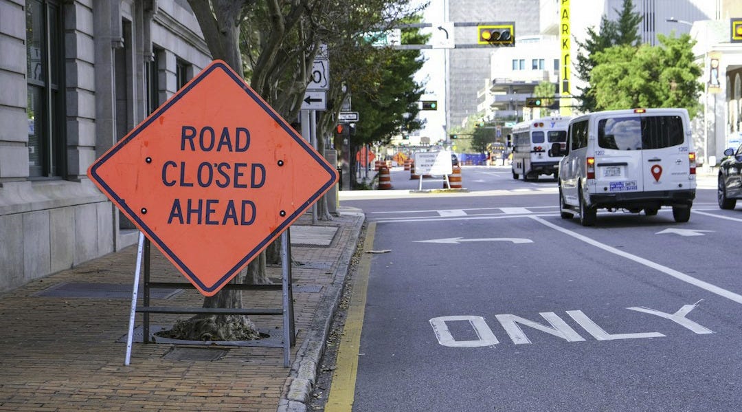 Road closed ahead sign on city street Road closed ahead sign on city street