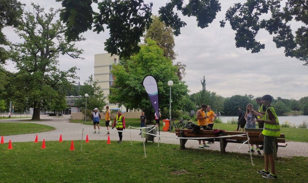 A view of the finish line showing the lake behind the path, and a housing block that overlooks the lake.