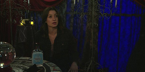 Cassie sitting with bottle of tequila at palm readers table on Walker. Cassie sitting with bottle of tequila at palm readers table on Walker.