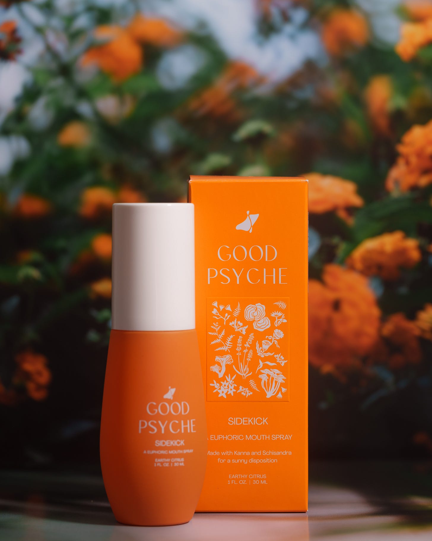 Good Psyche "Sidekick" euphoric mouth spray displayed against a background of orange flowers Good Psyche "Sidekick" euphoric mouth spray displayed against a background of orange flowers