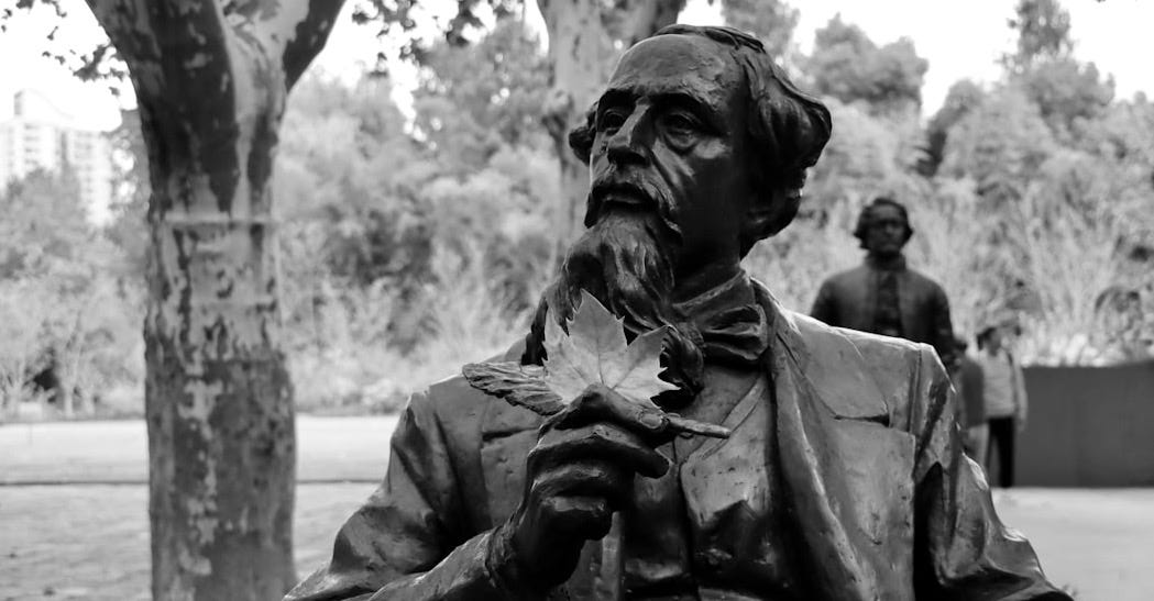 a statue of a man holding a leaf