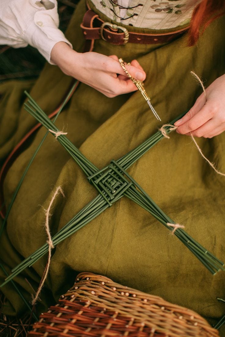 This may contain: a woman is sitting on the ground with some green yarn and scissors in her hands