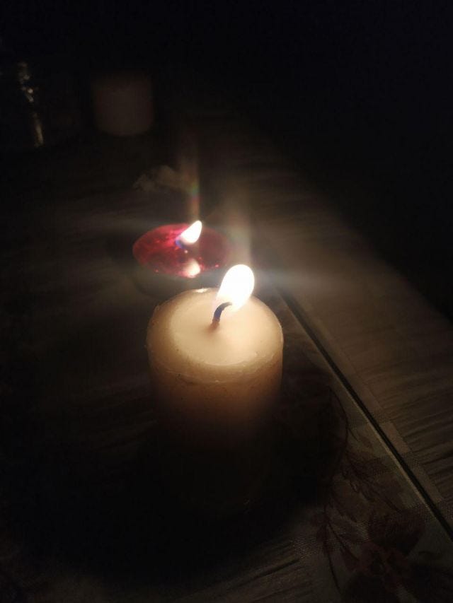 Two candles lit - one red and one white.