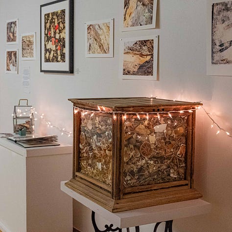 Triptych. Woman in green shirt puts her hands into a frame; layers of dried food scraps on a rack; a glass box filled with those dried scraps, mixed and mingled.