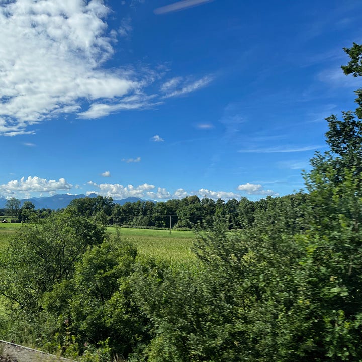 Photos taken out of a train carriage looking at summer Bavarian landscape