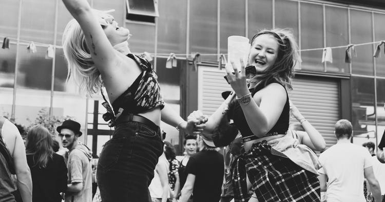 young women dance joyously at a party young women dance joyously at a party