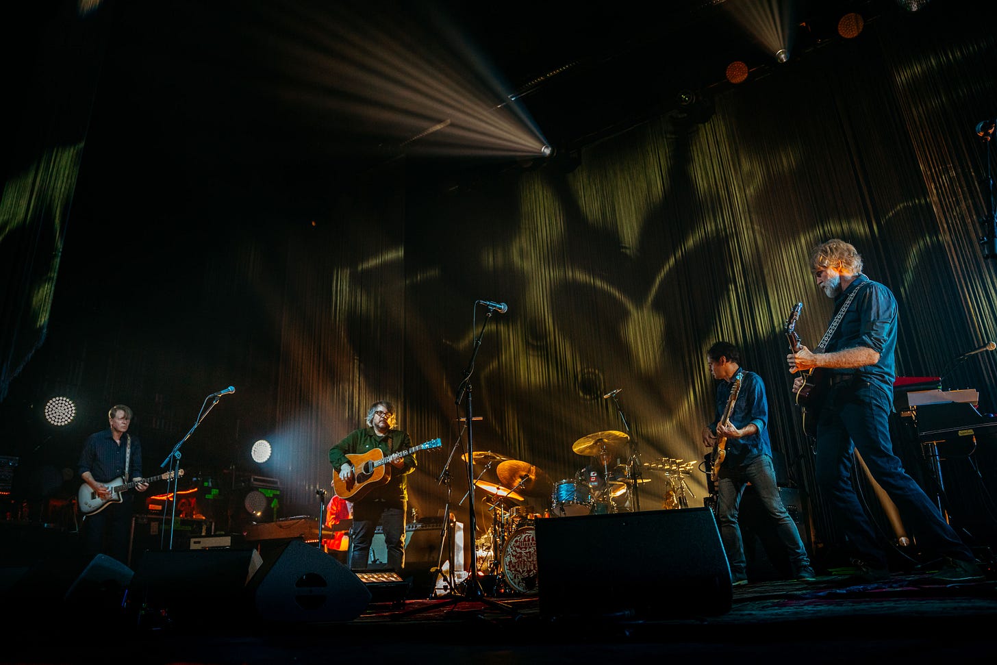 Wilco perform at the Riviera Theatre in Chicago in front of draped fiber set design.