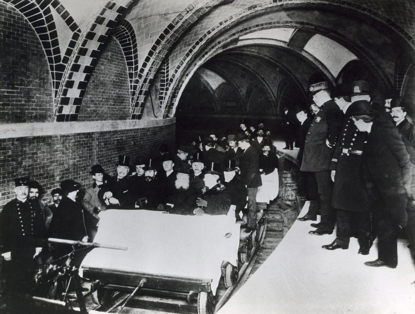 Crowded 1904 inaugural New York City subway car filled with formally dressed officials and guests seated and standing during the system’s opening run. Crowded 1904 inaugural New York City subway car filled with formally dressed officials and guests seated and standing during the system’s opening run.