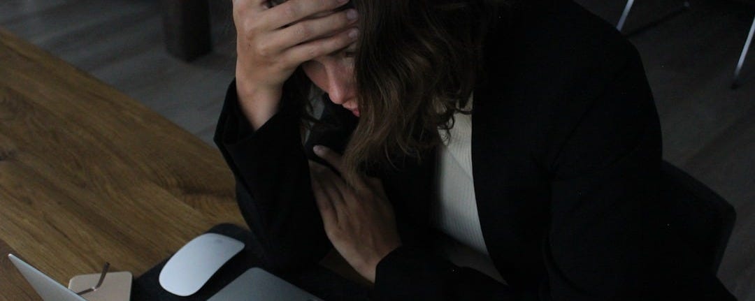 woman in black blazer sitting on chair