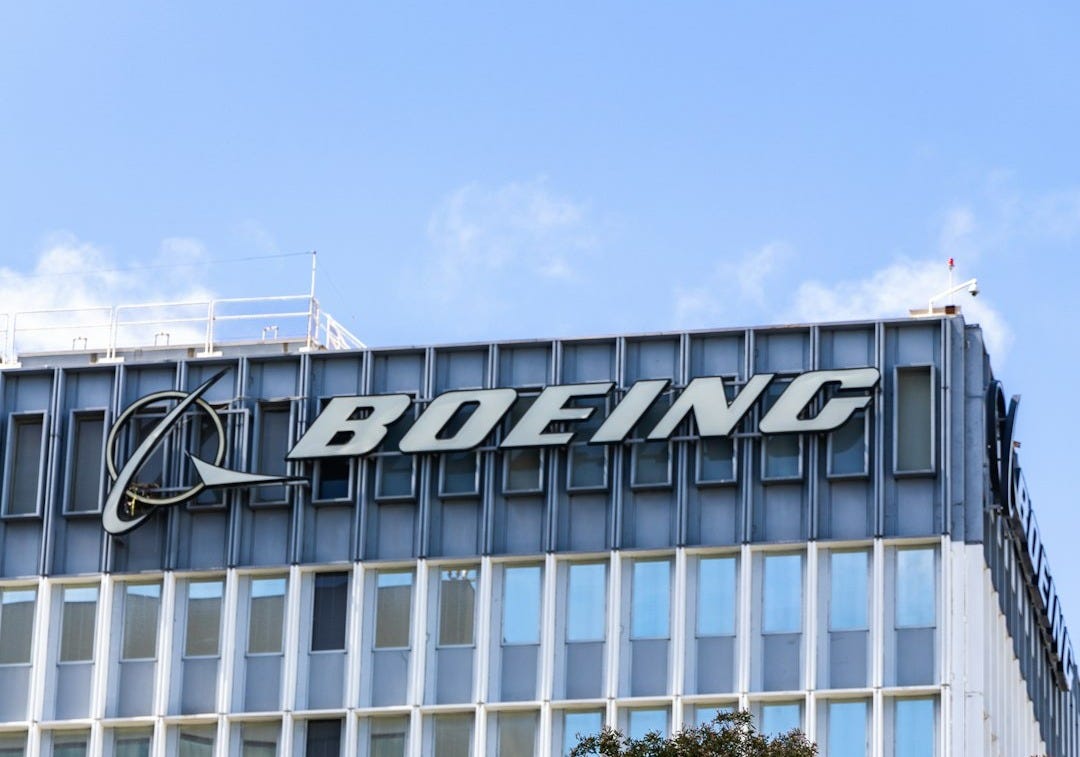 a tall building with a sign on top of it a tall building with a sign on top of it